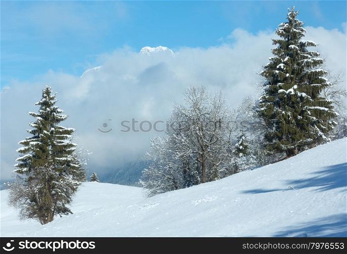 Winter mountain landscape with low-hanging clouds on slope (Austria, Bavaria).