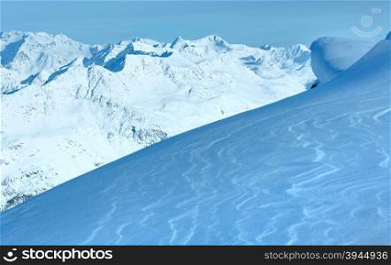Winter mountain scenery from hill and shining snow on slope in front (Tyrol, Austria).