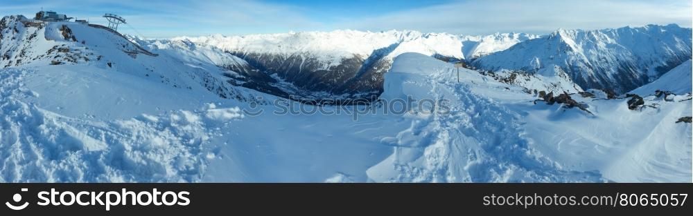 Winter mountain scenery with ski station on snowy slopes (Tyrol, Austria). Panorama.