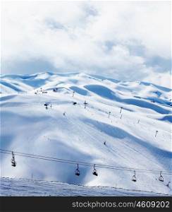 Winter mountain ski resort landscape with snow and chairlift