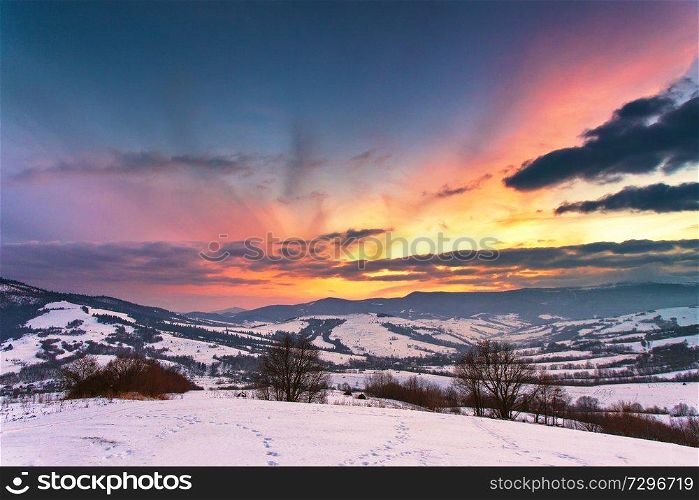 Winter mountain sunset. Fantastic evening winter landscape. Colorful overcast sky in Carpathian range, Ukraine