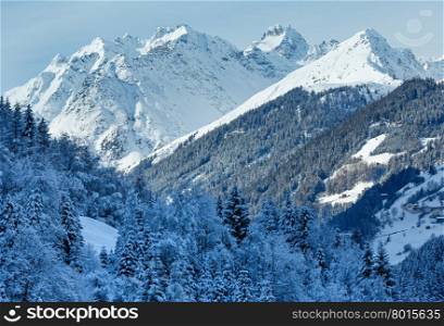 Winter mountain top view with forest on snowy slope (Austria, Tyrol).