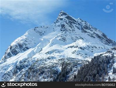 Winter mountain top view with forest on snowy slope (Austria, Tyrol).