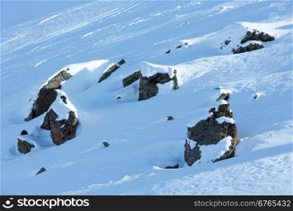 Winter mountain view with big stones on slope.