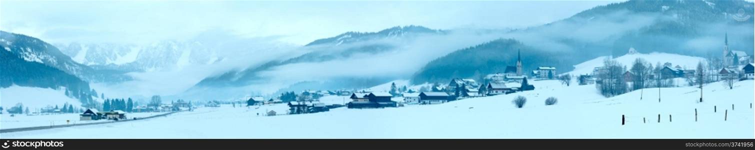 Winter mountain village hazy landscape with low-hanging clouds (Austria).