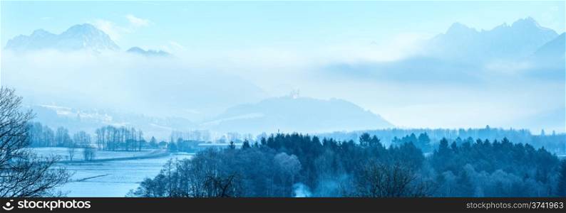 Winter mountain village misty landscape in Austria.