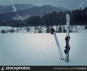 Winter mountains and ski equipment in the snow. Skiing resort winter holidays in Carpathians, Bukovel, Ukraine.