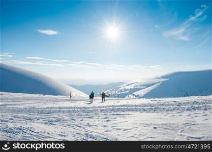 Winter mountains in snow and people with snowboards