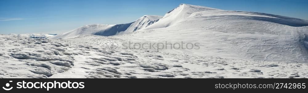 Winter mountains ridge with overhang snow caps(Ukraine, Carpathian Mt&rsquo;s, Svydovets Range, Blyznycja Mount, Drahobrat ski resort). Twenty shots stitch image.