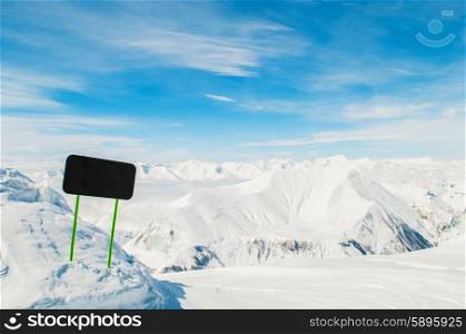 Winter mountains with blank sign