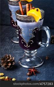 Winter mulled wine. Christmas mulled wine with an orange slice in a stylish glass