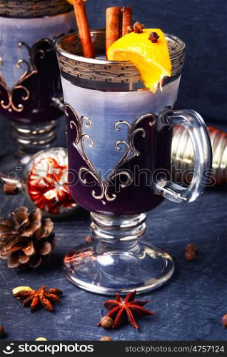 Winter mulled wine. Christmas mulled wine with an orange slice in stylish wineglass