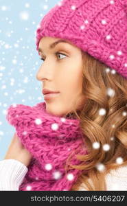 winter, people and happiness concept - beautiful woman in pink winter hat and muffler