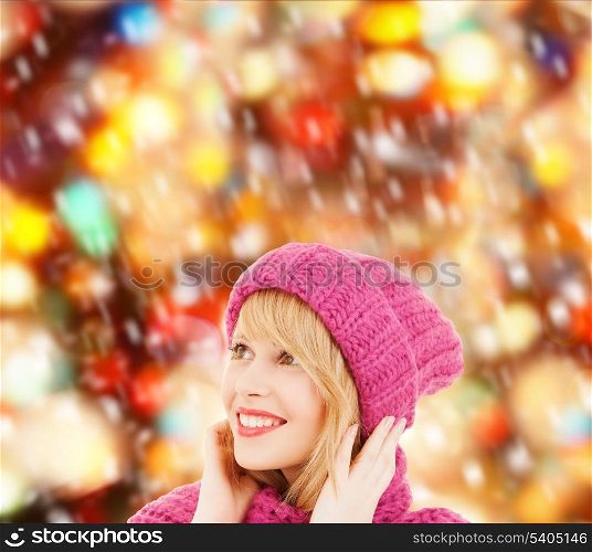 winter, people and happiness concept - woman in pink hat and scarf