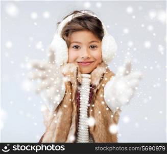 winter, people, childhood and happiness concept - happy little girl in winter clothes