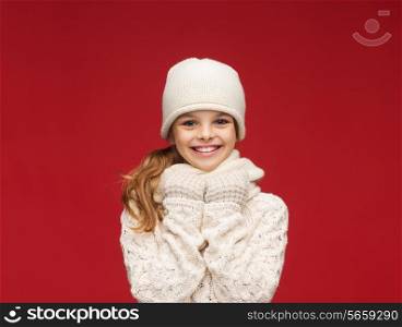 winter, people, happiness concept - girl in hat, muffler and gloves