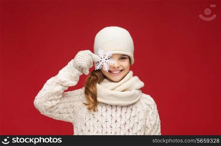 winter, people, happiness concept - girl in hat, muffler and gloves with big snowflake