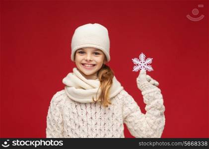 winter, people, happiness concept - girl in hat, muffler and gloves with big snowflake