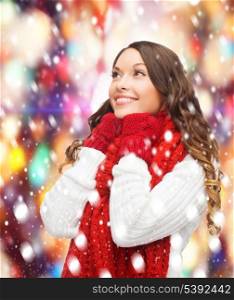 winter, people, happiness concept - happy woman in sweater, scarf and mittens