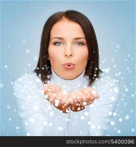 winter, people, happiness concept - happy woman in white sweater blowing on palms