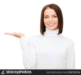 winter, people, happiness concept - smiling woman in white sweater with something on palm