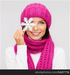 winter, people, happiness concept - woman in hat and muffler with big snowflake