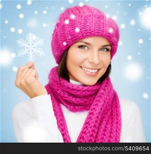 winter, people, happiness concept - woman in hat and muffler with big snowflake
