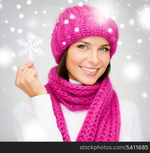 winter, people, happiness concept - woman in hat and muffler with big snowflake