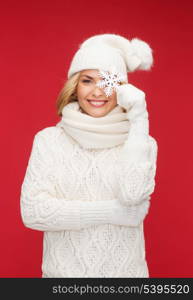 winter, people, happiness concept - woman in hat, muffler and gloves with big snowflake