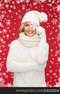 winter, people, happiness concept - woman in hat, muffler and gloves with big snowflake