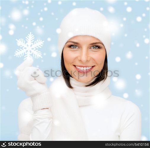 winter, people, happiness concept - woman in hat, muffler and gloves with big snowflake