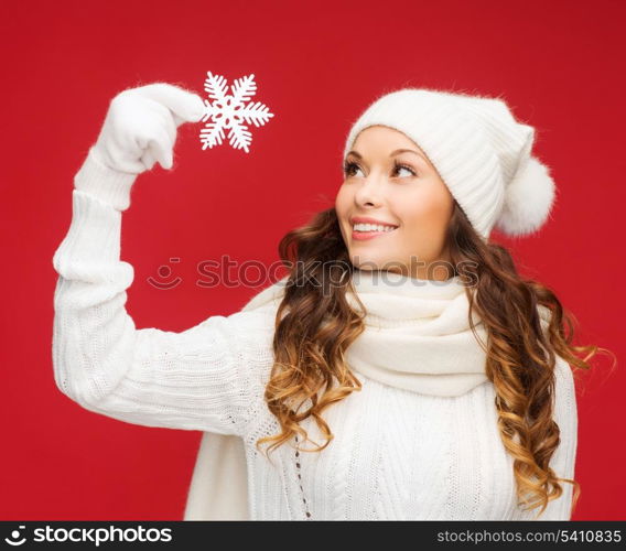 winter, people, happiness concept - woman in hat, muffler and gloves with big snowflake