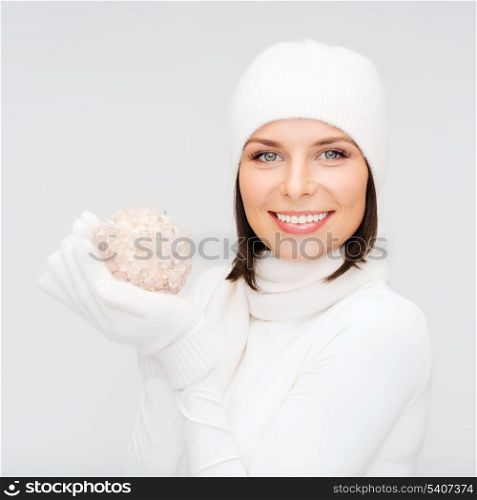 winter, people, happiness concept - woman in hat, scarf and gloves with christmas tree decoration