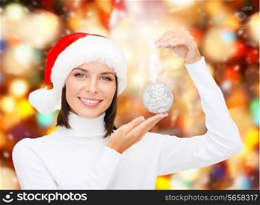 winter, people, happiness concept - woman in santa helper hat with christmas tree decoration over red lights background