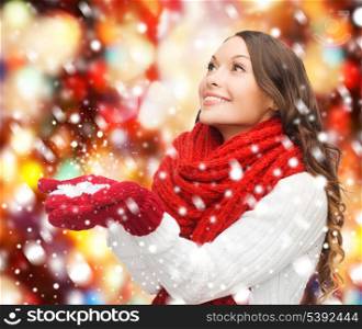 winter, people, happiness concept - woman in scarf and gloves with big snowflake