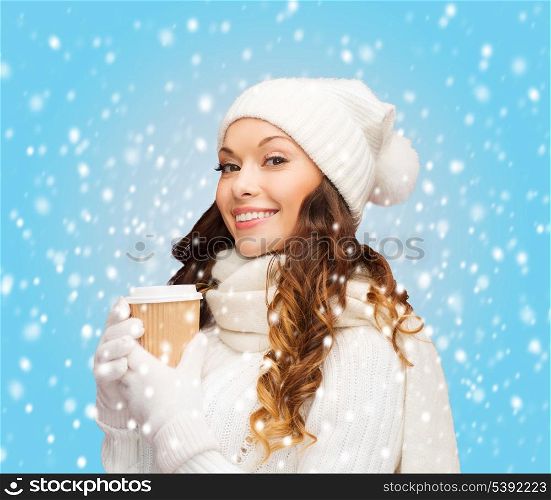 winter, people, happiness, drink and fast food concept - woman in hat with takeaway tea or coffee cup