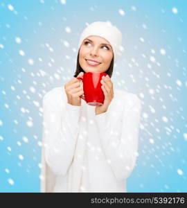 winter, people, happiness, drink and food concept - woman in hat with red tea or coffee mug