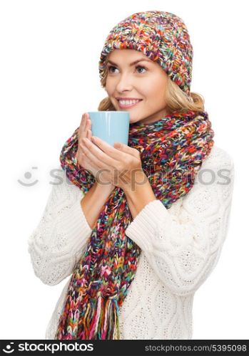 winter, people, happiness, drink and food concept - woman in hat with red tea or coffee mug looking up