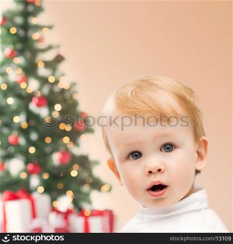 winter, people, x-mas, happiness concept - happy little boy with christmas tree and gifts