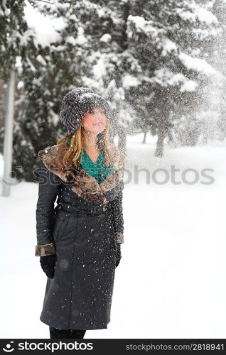 winter portrait of a beautiful blonde dressed in a fur hat