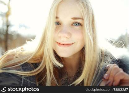 winter portrait of a cute blonde teen