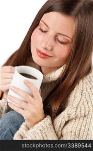 Winter portrait of happy woman holding cup of coffee wearing turtleneck on white