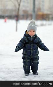 Winter portrait of toddler boy in warm coat outdoors