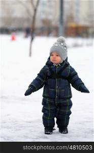 Winter portrait of toddler boy in warm coat outdoors