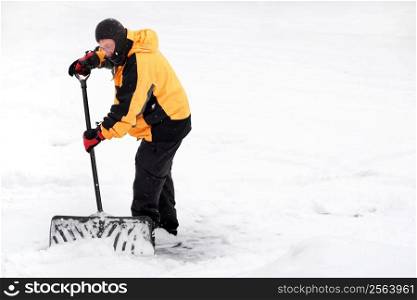 Winter scene with a man shoveling snow