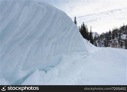 Winter scenery in Austrian mountains with huge snowdrifts on the roadside. Snowy road in the Austrian Alps.
