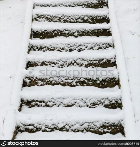 Winter season and seasonal specific. staircase outdoor covered with snow