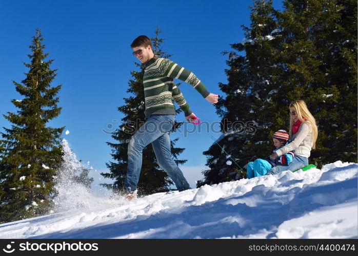 Winter season. Happy family having fun on fresh snow on vacation.