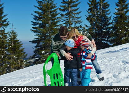 Winter season. Happy family having fun on fresh snow on vacation.