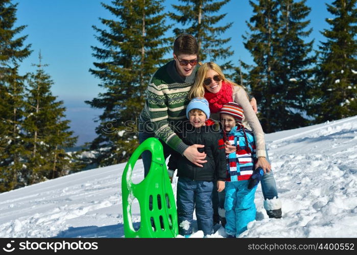 Winter season. Happy family having fun on fresh snow on vacation.